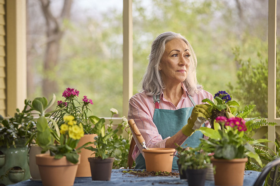 woman planting flowers in pots