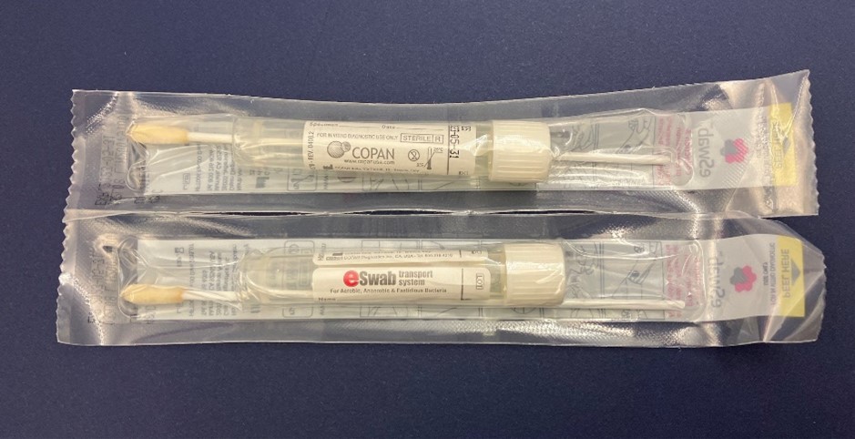 "An overhead image of two sealed, unopened ESwab Collection Kit for Candida clinical specimen collection."
