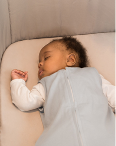 baby sleeping on a bed