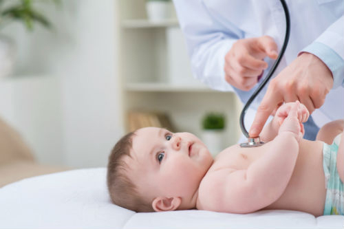 "A pediatric doctor examining an infant."
