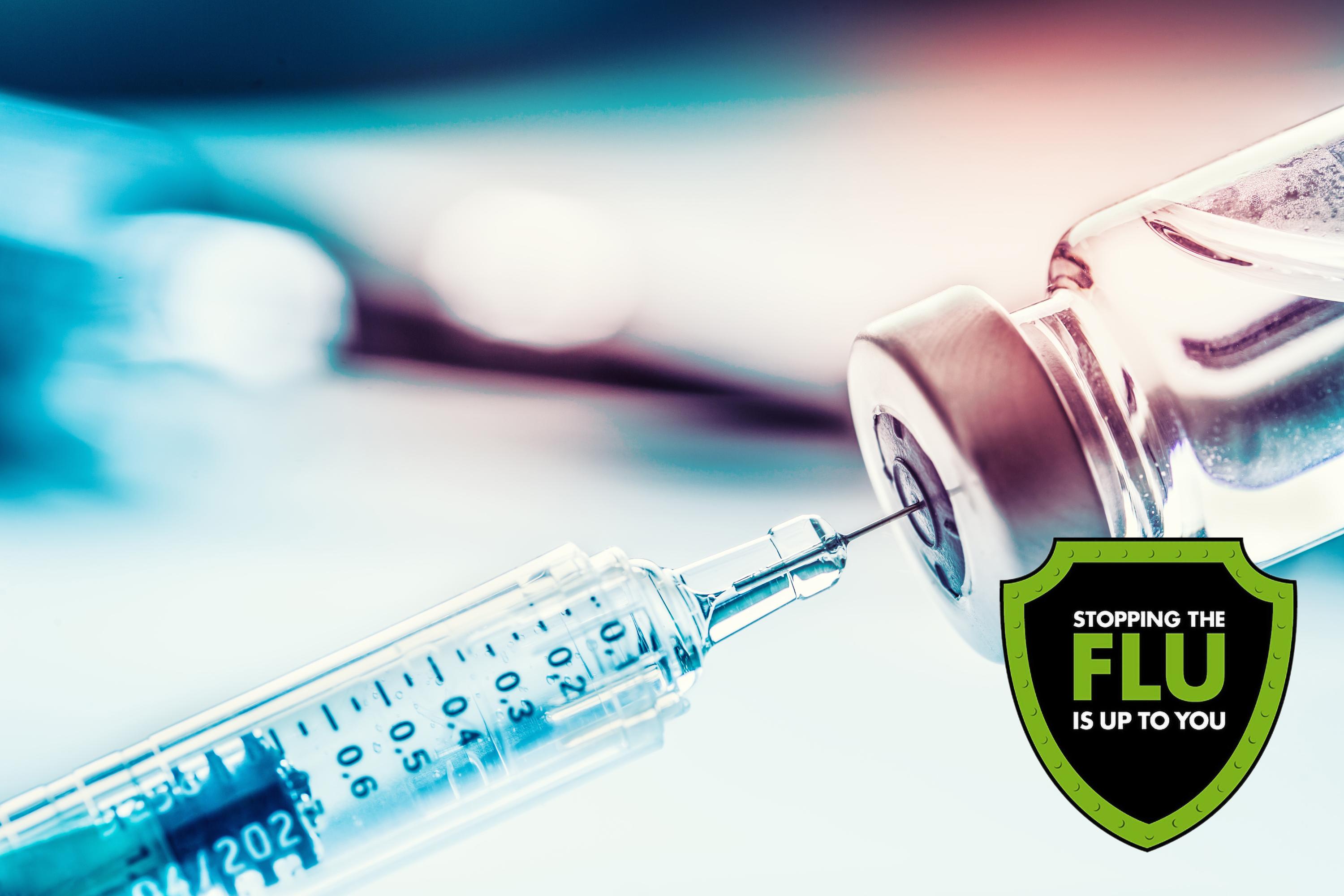 Image of a syringe next to a green and black shield icon that reads "Stopping the Flu is up to you".