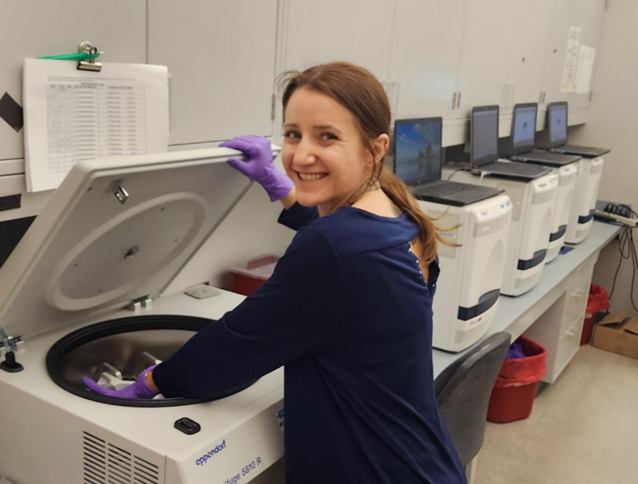Personnel working on a centrifuge.