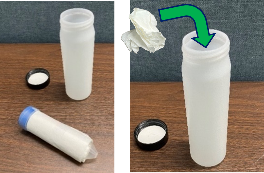 A white plastic secondary container placed on a table top with its lid next to it. A wrapped specimen collection tube is on the table in front of the container.  