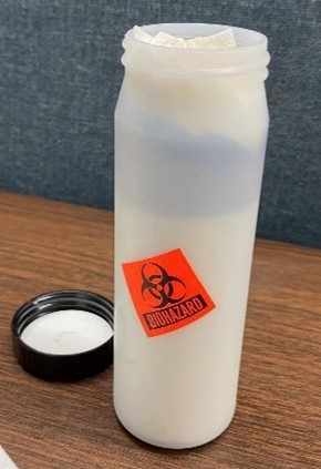 A white, cylindrical, hard-sided plastic secondary container 