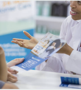 Pharmacy customer reads flu vaccine flyer