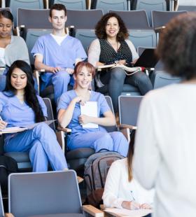 A professor teaching to a class 