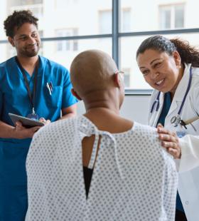 nurse and doctor examining an elderly man