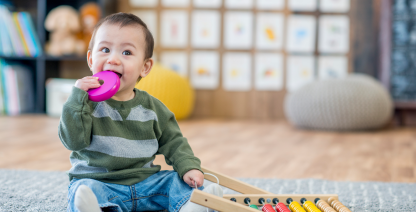 A baby plays with toys.