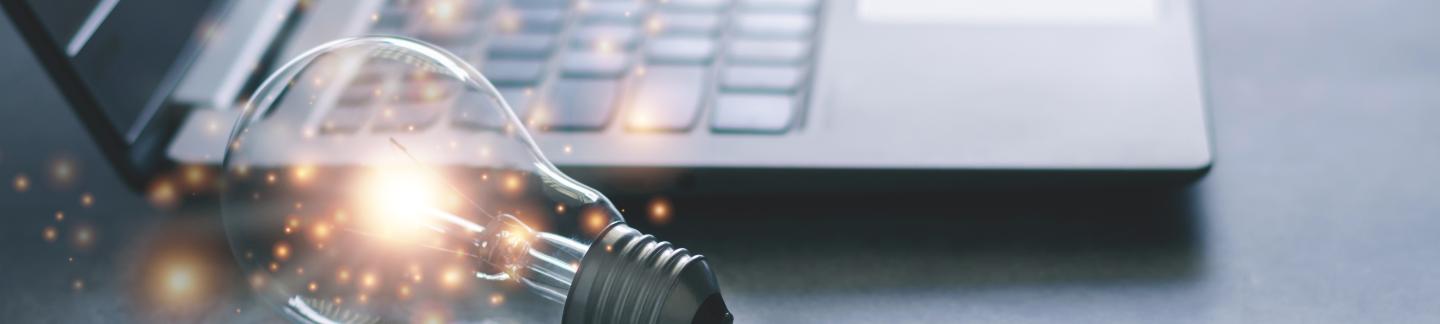 Laptop and Glowing Lightbulb