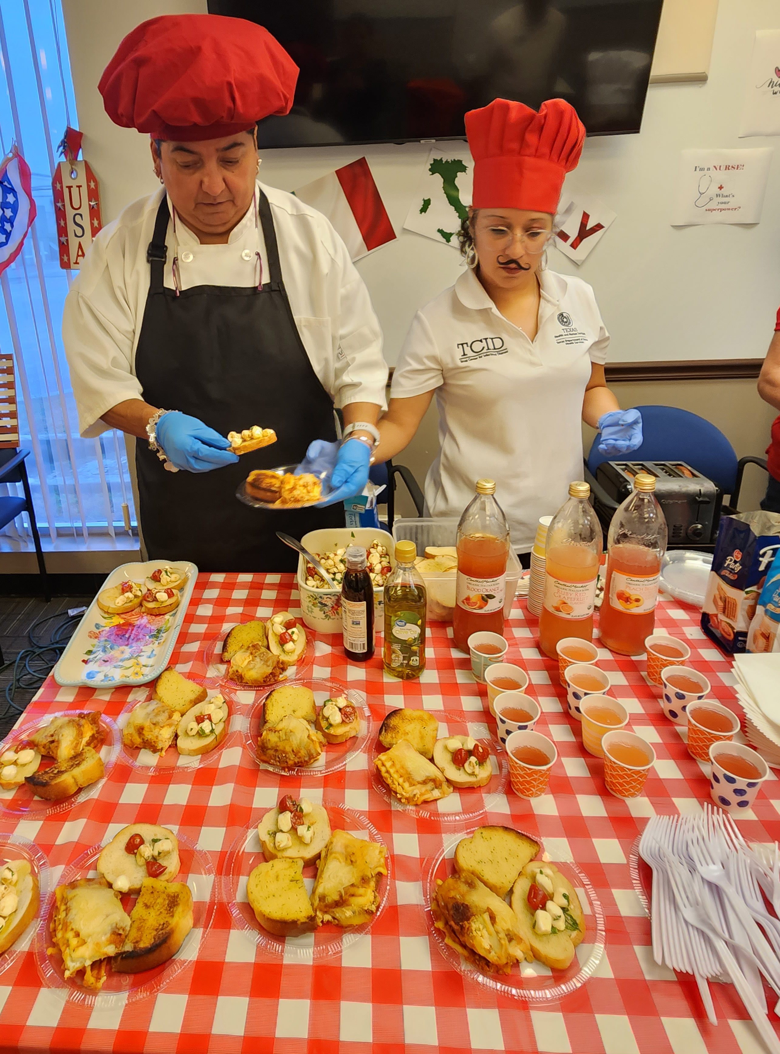 Two chefs wearing chef hats preparing food 