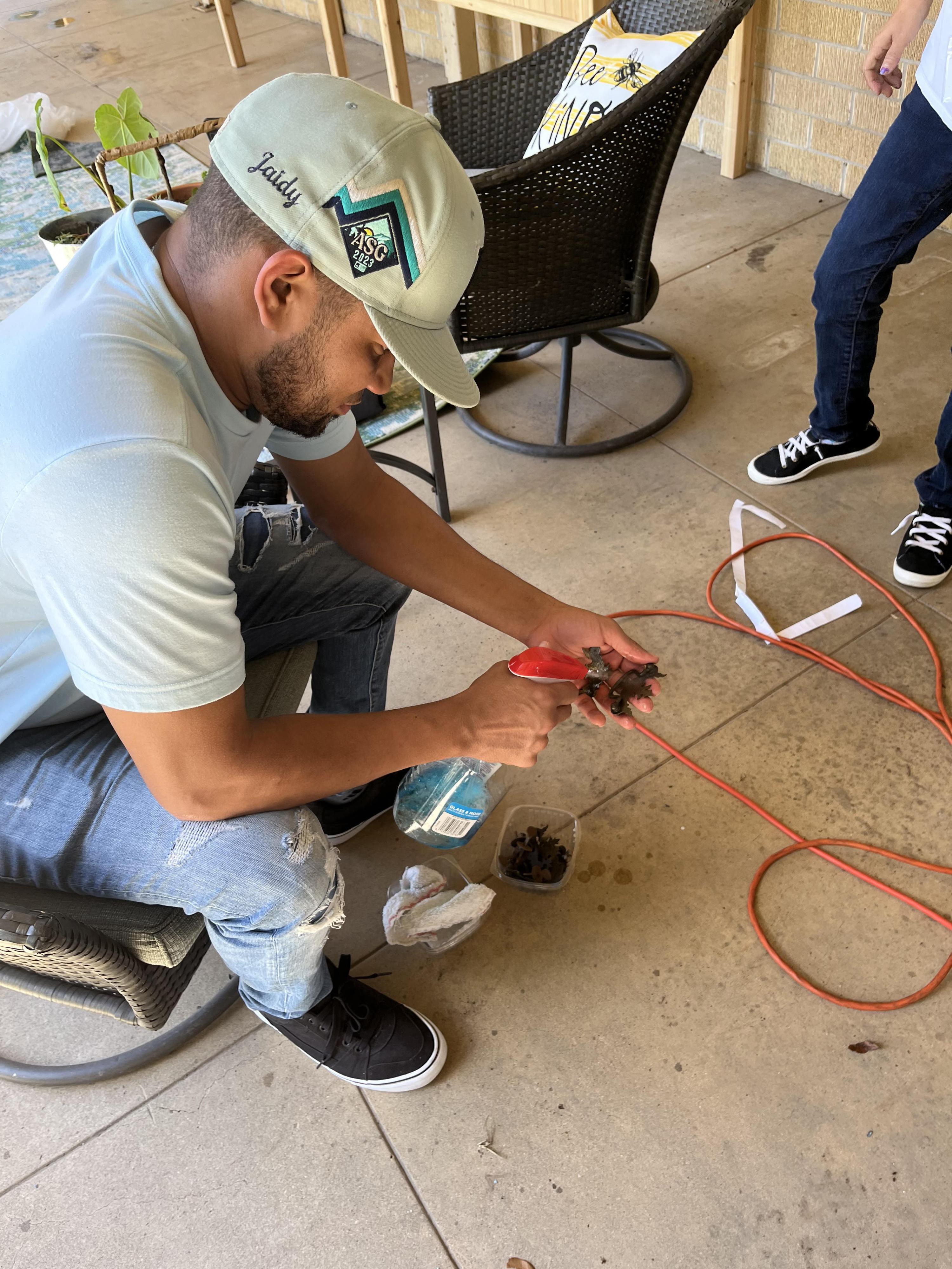 A man cleans a piece of electrical equipment