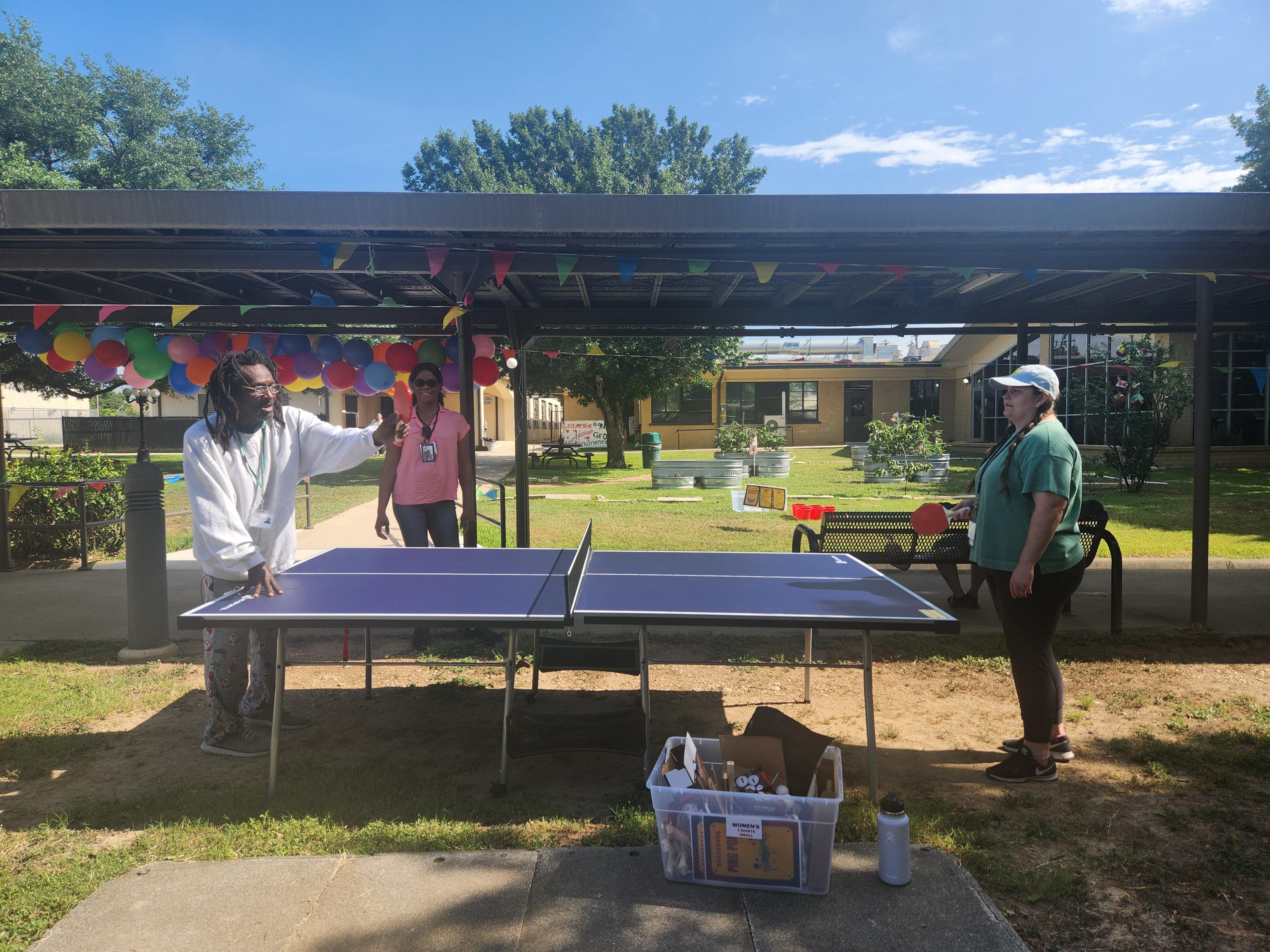 A man and a woman playing ping pong