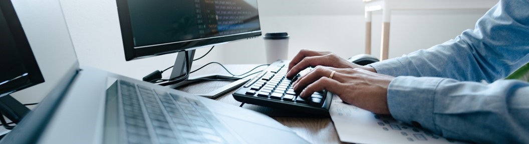 Picture of a person's hands typing on a keyboard, decorative