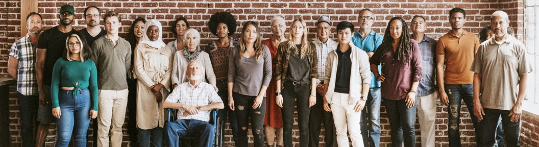 group of people standing in front of a wall