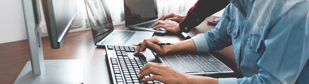 Two people's hands on keyboards, decorative
