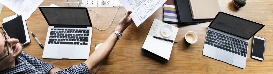 People holding papers at a table, decorative