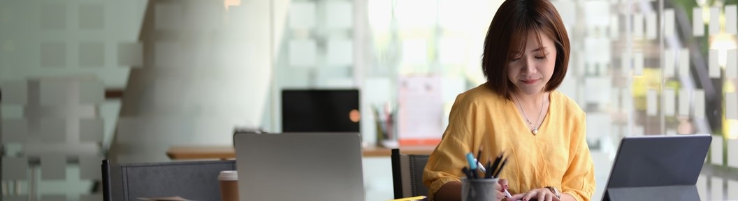 Woman in a sunny room with laptop, decorative