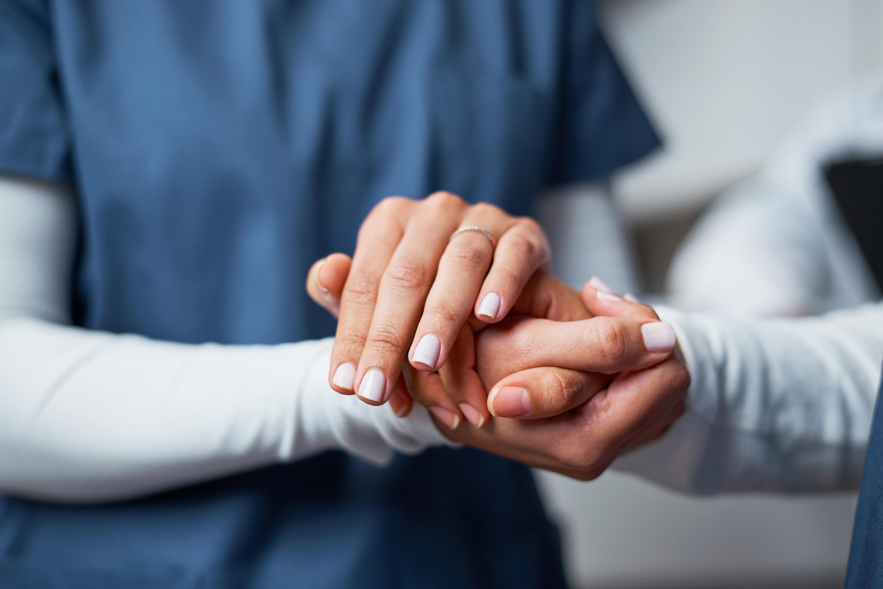 doctor holding the hand of a patient