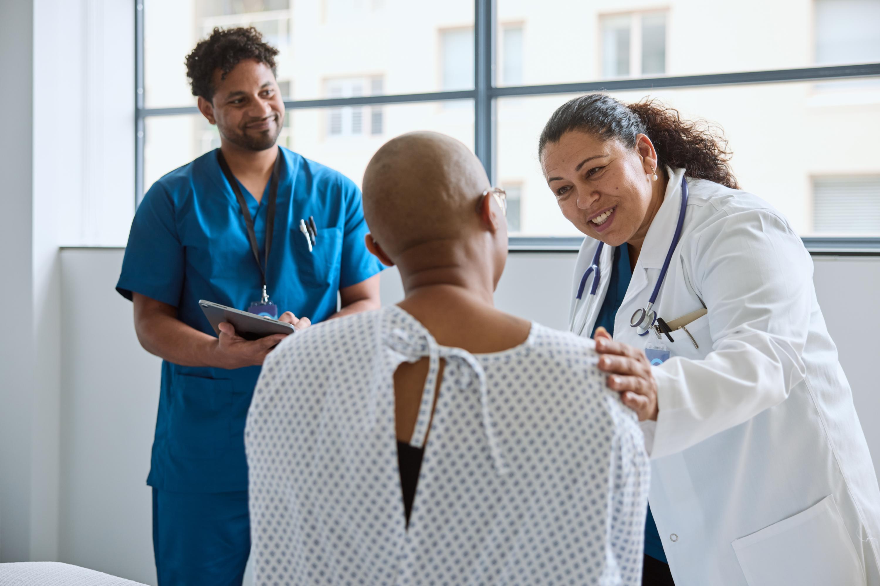 Nurse and doctor consult with a patient.