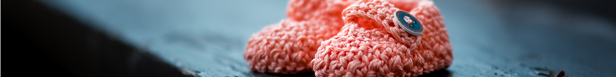 Pink knitted baby shoes