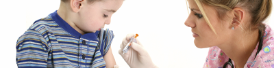 A nurse gives a child a shot