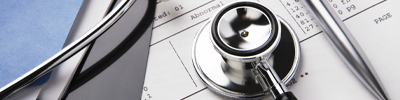 Stethoscope rests on paperwork