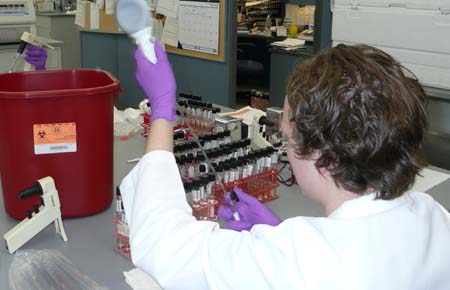 Photo of a Consumer Microbiology Analyst testing Texas bay water samples for the presence of Fecal Coliforms.