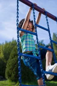 Young girl on jungle gym ladder