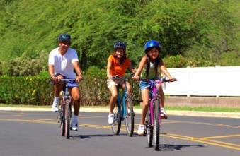 Three people family on bikes