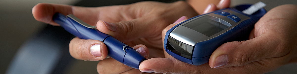 A person using a diabetes blood sugar testing device